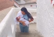 Mãe sobe escadas de joelhos e com bebê no braço em promessa e vídeo viraliza